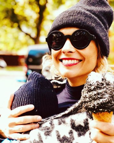 Picture of Myanna Buring with her two favorite things: her son and ice cream